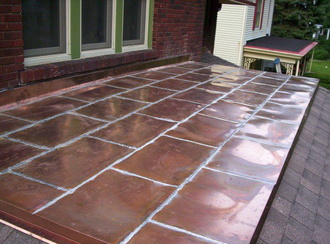 Flat copper roofing system over a porch