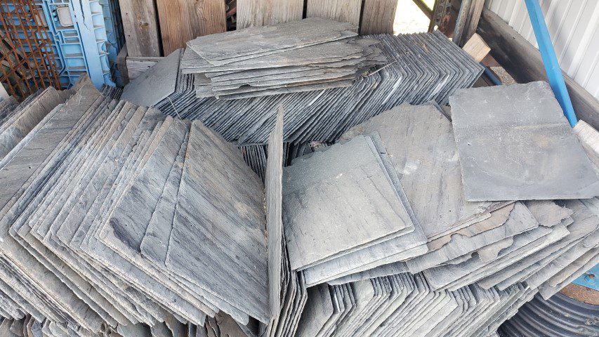 Reclaimed slate roofing tiles packed in crate
