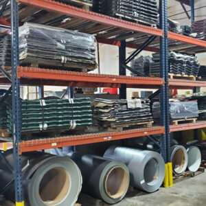 Metal shelving holding pallets of metal roofing products