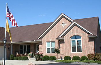 Metal Shingle roof panels in Hickory color on home