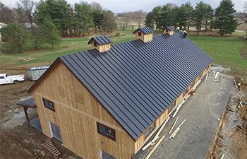 Large standing seam meal roof on newly constructed barn