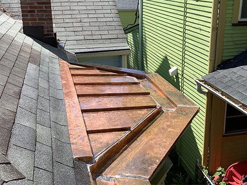Close up of copper standing seam and built in copper gutter