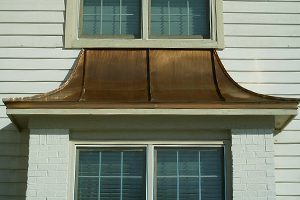 Copper bay window cover on home