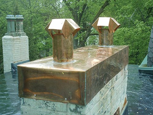 Copper chimney cap on home