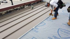 Working installing a standing seam roof